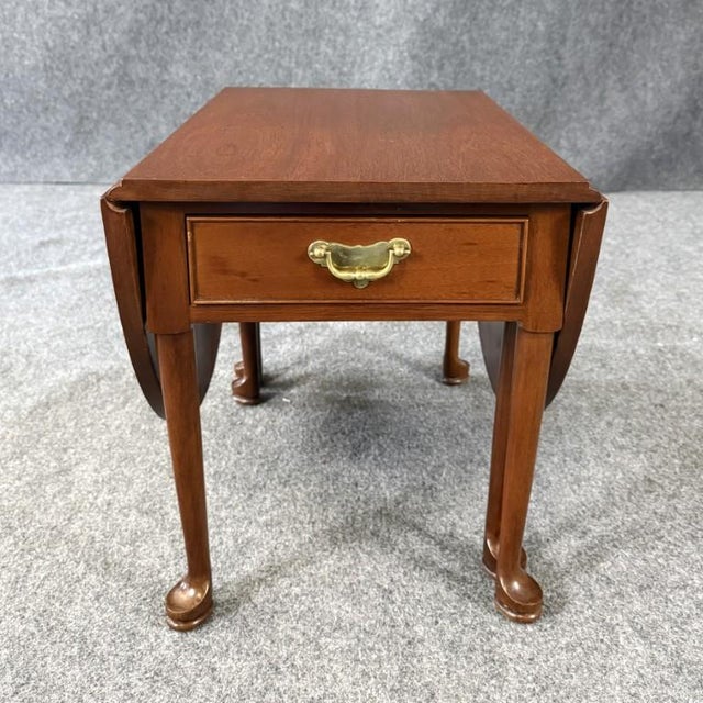 This Norris reproduction diminutive gate leg table is crafted from solid mahogany and features a classic drop-leaf design...