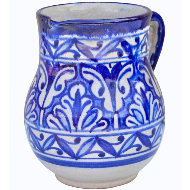 Stunning one-of-a-kind antique Moroccan ceramic pitcher meticulously handcrafted and glazed in an ornate curved silhouette...