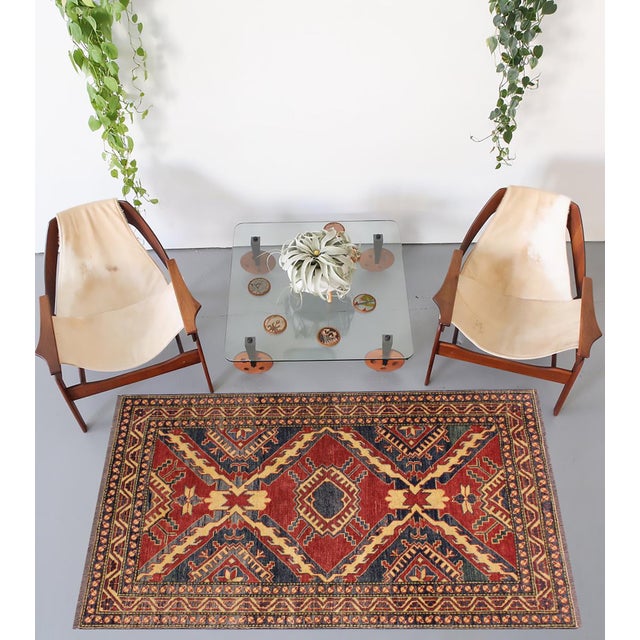 Enhance your home with this exquisite hand-knotted Super Kazak rug, crafted from fine hand-spun wool and dyed with all-...