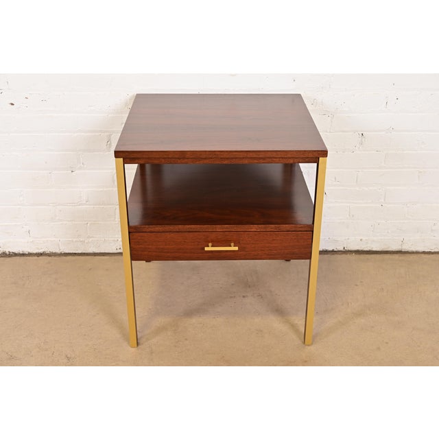 A sleek and stylish Mid-Century Modern two-tier single drawer nightstand or end table By Paul McCobb for Calvin Furniture,...