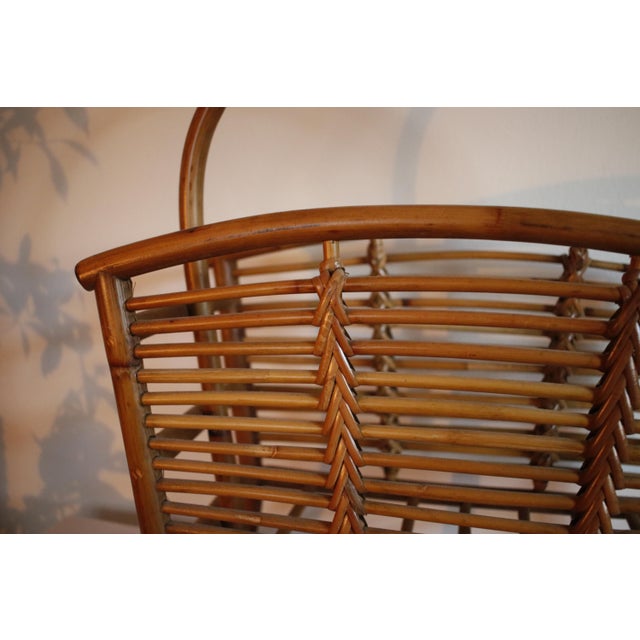 Elevate a space with this vintage bentwood magazine rack, crafted from warm-toned bamboo and featuring intricate rattan...