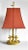 A vintage tole bouillotte electric lamp in an aged mustard yellow base, with white candle sleeves, and a rust red square...