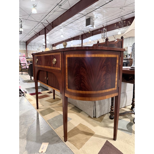 A finely crafted inlaid mahogany buffet that reflects classic craftsmanship with a refined silhouette and rich tonal...