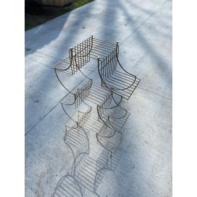 Fabulous shape on this Mid Century plant stand that holds (9) 6” pots in a small footprint.