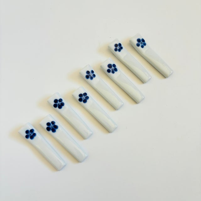 A set of 8 vintage ceramic chopstick rests. Each has a lovely hand painted floral design and finished in blue and white...