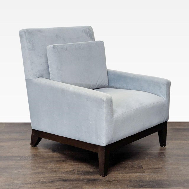 This West Elm lounge chair features a soft gray upholstery and sturdy dark wood legs. Its simple, modern design offers...
