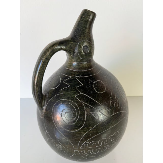 Striking vintage handmade pottery vase featuring a sculptural organic silhouette with an elongated neck and integrated...