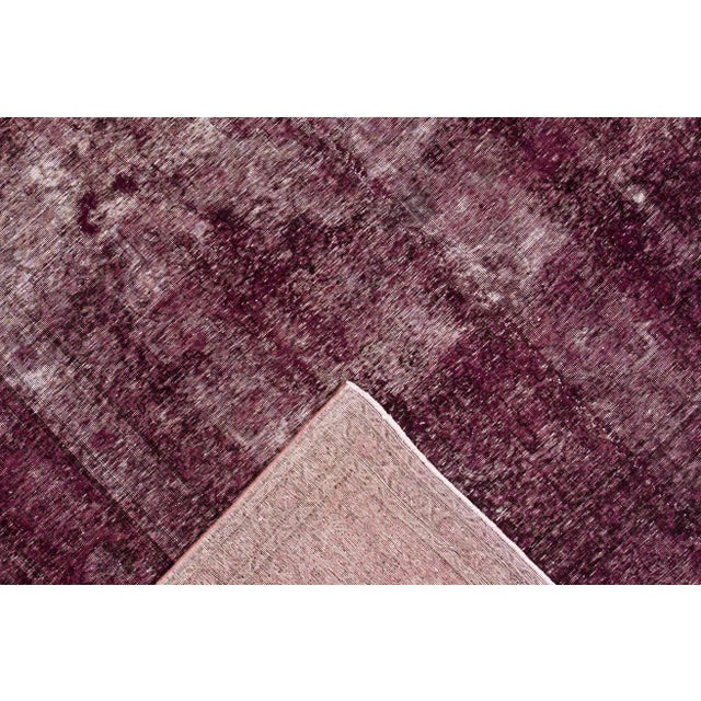 A hand-knotted Overdyed rug with an allover design. This rug measures 8'7"x11'7"