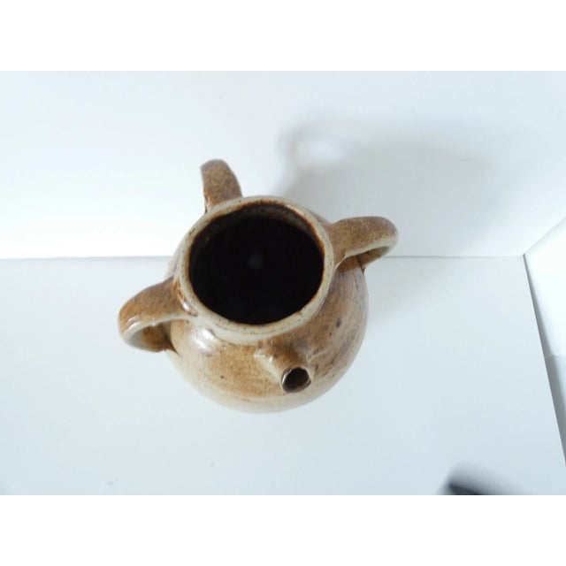 19c. 3 handled amphora jug with a small spout. Light beige patina on the bottom and brown on top. No major defaults....