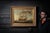 Mid-20th-century oil on canvas depicting a British sailing ship underway on choppy seas beneath a dramatic cloud-filled...