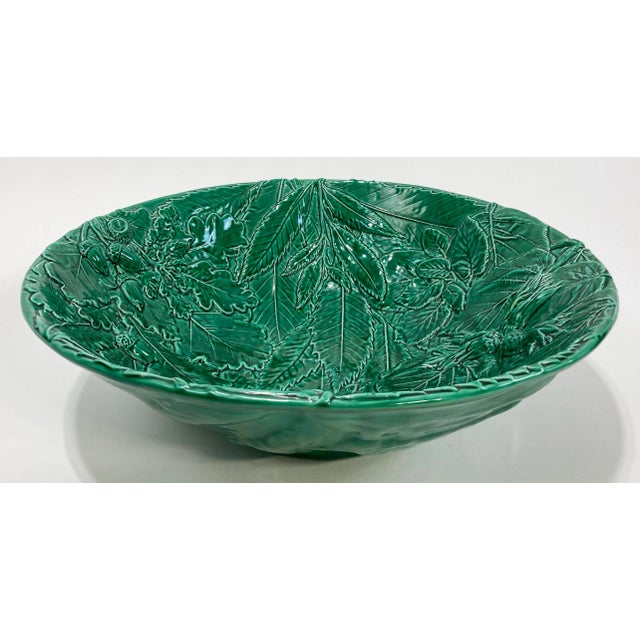 Oversized ceramic decorative bowl in a stunning vibrant green featuring raised relief acorn and leaf pattern inside bowl....
