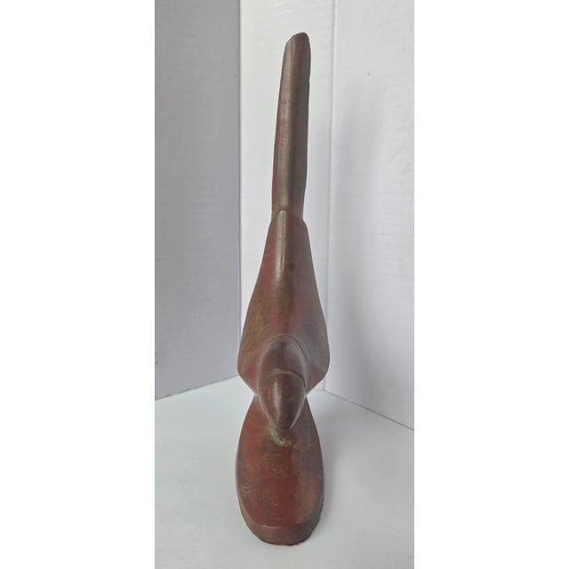 Beautifully crafted parrot sculpture. Sleek mid-century modern styling and a classic aged finish, this striking bird...