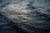 This photograph captures the fluid dynamism of waves, emphasizing their rhythmic movement and interplay of light. The...