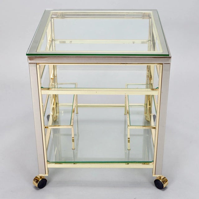 Vintage trolley circa 1960s. This brass framed bar cart features bottle racks and two glass shelves. Gorgeous accent piece...