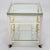 Vintage trolley circa 1960s. This brass framed bar cart features bottle racks and two glass shelves. Gorgeous accent piece...