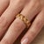 Radiating warmth and sophistication, this exquisite eternity ring is crafted from 925 sterling silver and finished with a...