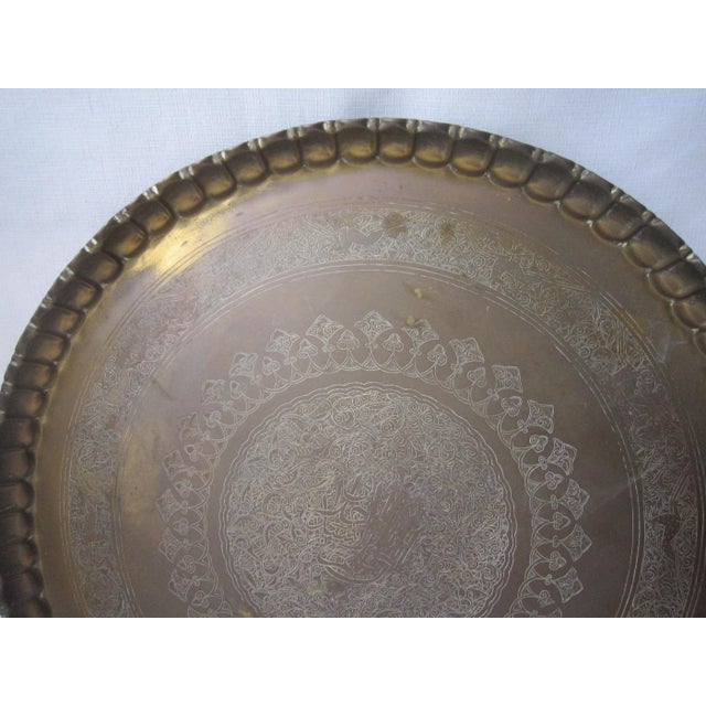Large Moroccan brass decorative tray. Piecrust edge, it measures 32"D and is in excellent condition. Does not have hanging...