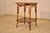 19th century bamboo side table from France. The top has a parqueted border with geometric patterns, surrounding a hand...