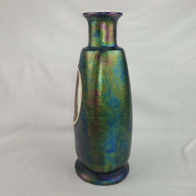 Antique iridescent art glass vase showcases a stunning peacock-inspired oil slick finish with deep blue, green, and purple...
