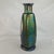 Antique iridescent art glass vase showcases a stunning peacock-inspired oil slick finish with deep blue, green, and purple...
