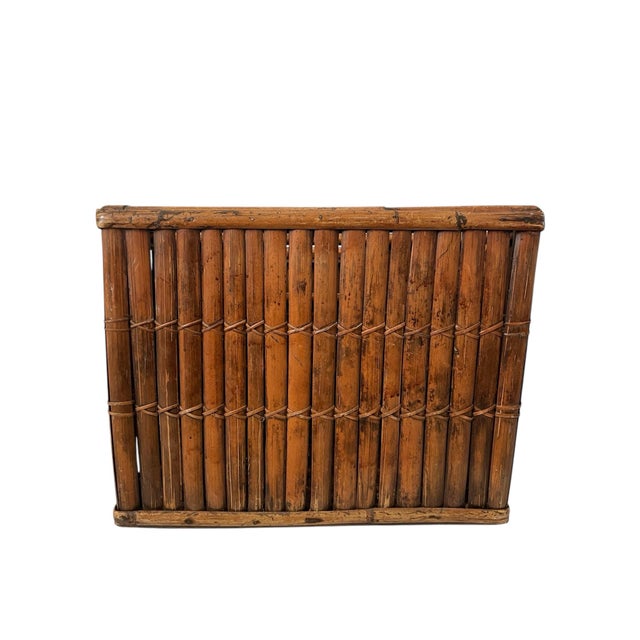 This Vintage MCM Burnt Bamboo Magazine Rack is a handmade piece that adds a unique touch to any room with its boho tiki...