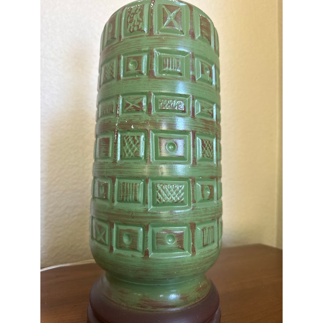 A striking sculptural ceramic lamp featuring a richly textured geometric relief pattern inspired by Brutalist design and...