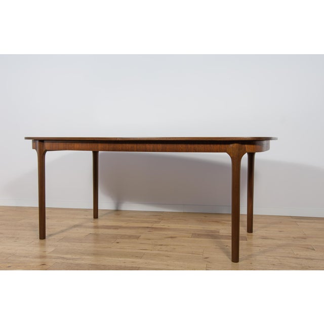 This oval extendable dining table was produced by McIntosh in the 1960s. Teak elements cleaned old surface and painted in...