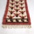 Charming small vintage Swedish rya rug from the 1950s. Geometric flower pattern in red, yellow and brown against a white...