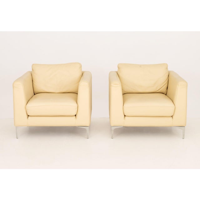 Pair of Nicoletti Off-White Leather Upholstered Club Chairs, each marked "Nicoletti Italy" beneath cushion and above...
