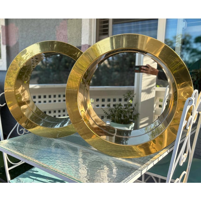 These stunning vintage brass “porthole” mirrors are the work of Artisan House founders Curtis Freiler and Jerry Fels (C....