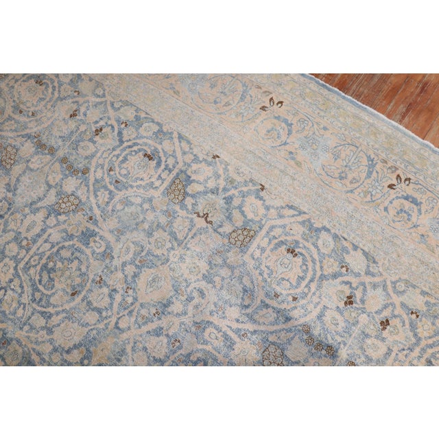 An early 20th century Persian Tabriz rug Measures: 10'9'' x 18'6''.