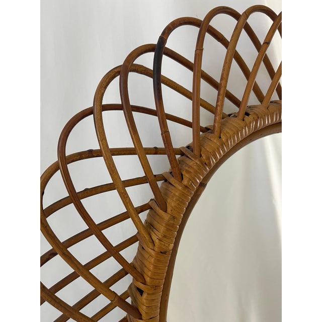 Italian Riviera original hand woven oval rattan mirror with burgundy velvet backing. Designed by Franco Albini, c. 1960's....