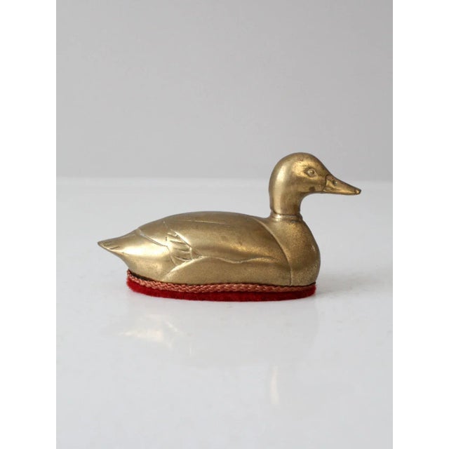 Charming and highly decorative, this mid-20th-century brass duck lint brush is a wonderful example of the era’s penchant...