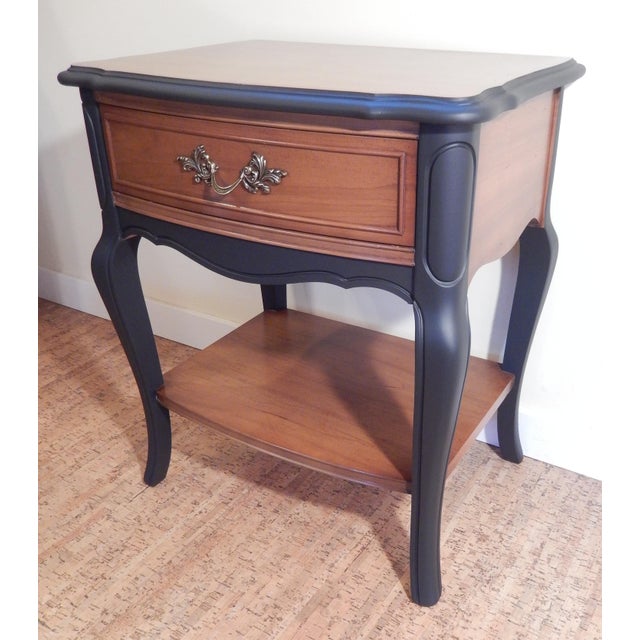 Striking French Provincial nightstand that has been hand-crafted by the Dixie furniture company, renown for their high...