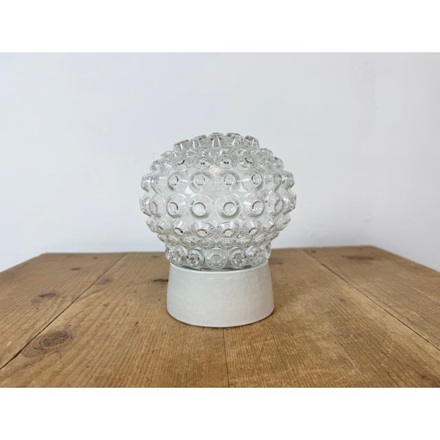 Vintage industrial ceiling or wall light made in former Czechoslivakia during the 1970s. It features a white porcelain...