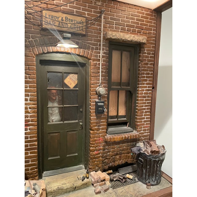 This is an early (@1975) Michael Garman's cityscape sculpture featuring Bertha's Bar & Grill, part of his "Magic Town"...