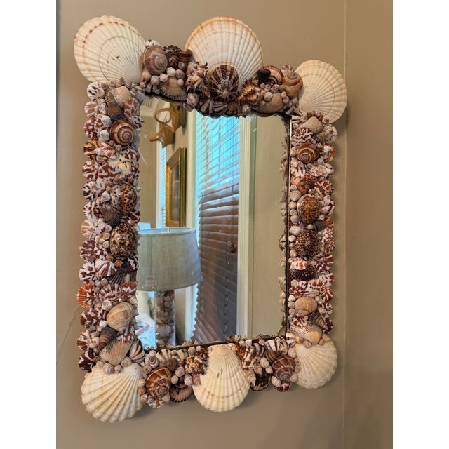 This one-of-a-kind shell-encrusted antique mirror is beautifully embellished with an abundant collection of natural...