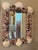 This one-of-a-kind shell-encrusted antique mirror is beautifully embellished with an abundant collection of natural...