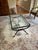 Elegant glass table with beveled glass. It would look beautiful in a living room or study. The date this was made is...