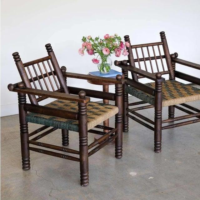 Stunning pair of 1940's French oak and woven armchairs by Charles Dudouyt. Beautiful carved wood detail throughout with...