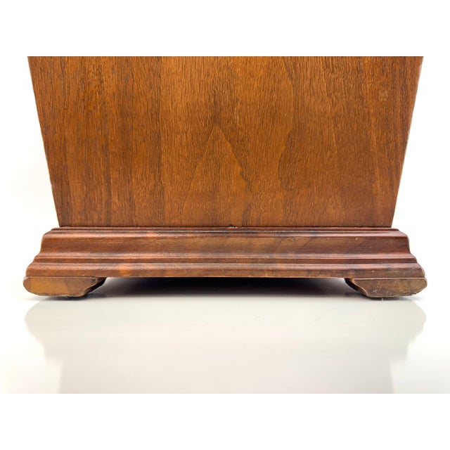 A well-crafted mid-century walnut wastebasket featuring clean, architectural lines and a gently flared form. The sides are...