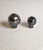 Pair of large modelled, ball shaped lamp shade finials with metallic black glaze. (there is a smaller size available)...