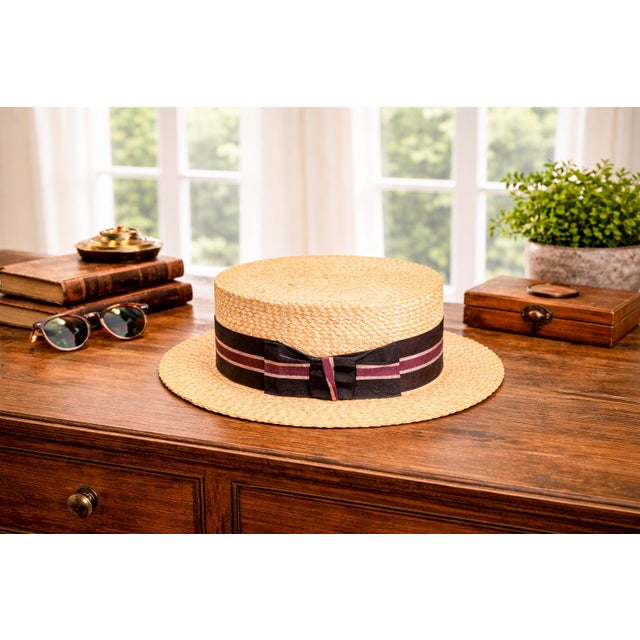 A timeless expression of mid-century elegance, this circa 1950s boater cap embodies the refined sporting style long...