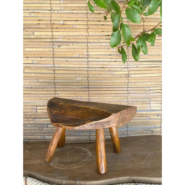 This stool is a footstool, with a four-star base. It is free-form with a Brutalist style. Its color is brown, it was made...