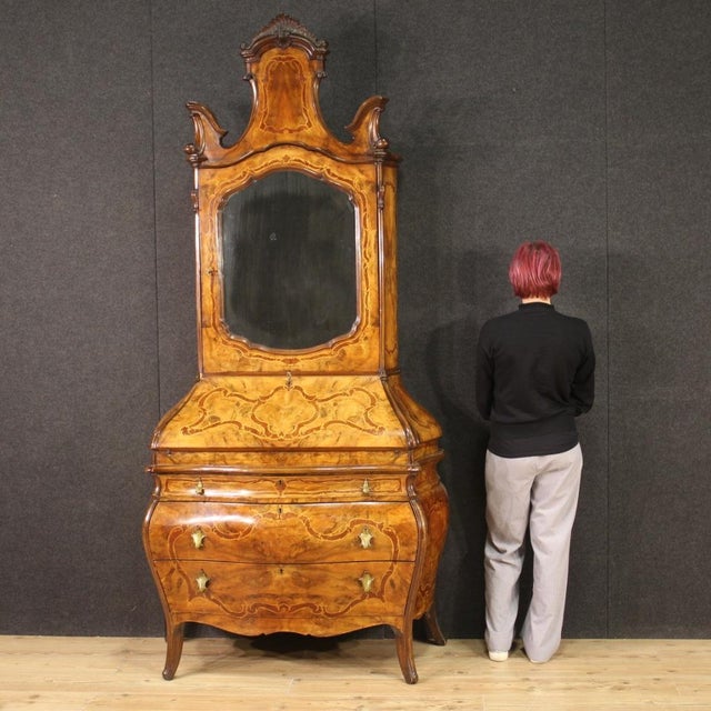 Lombard trumeau from the mid-20th century. Moved and rounded furniture in Rococo style richly inlaid in walnut, burl,...