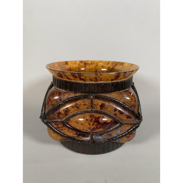 Blown glass vase in a wrought iron frame. Signed Le Lorrain Nancy. Shaded orange glass. French work, early 20th century,...