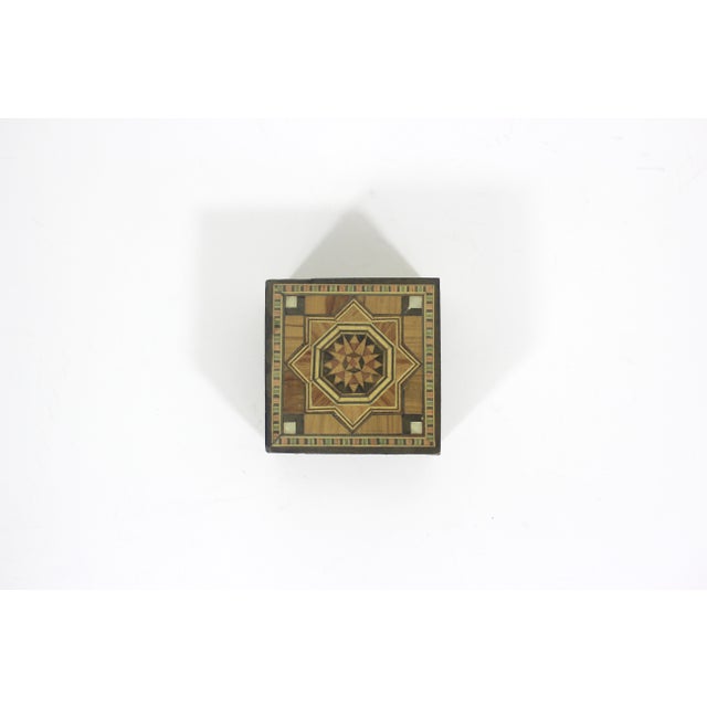 Charming, small handmade wood marquetry square box. The lid comes off and there is a red velvet lining. This has some...