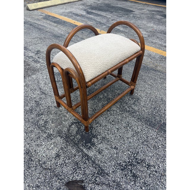 A charming vintage mid-century Italian vanity stool crafted in rattan with a light, airy silhouette and sculptural arched...
