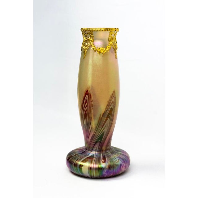 Blown glass incorporating colored ribbons drawn while hot using the Marmoriertes Glas technique—a process that involves...