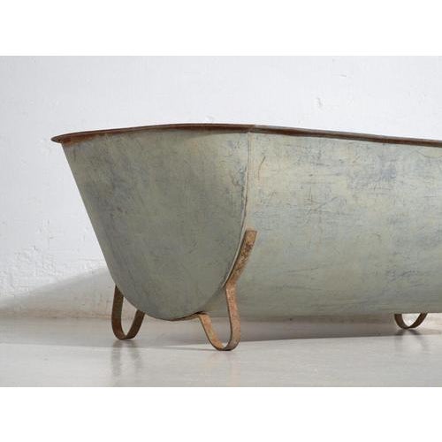 Antique galvanized zinc bathtub with iron structure, originating from Central Europe, circa 1900. This type of metal tub...